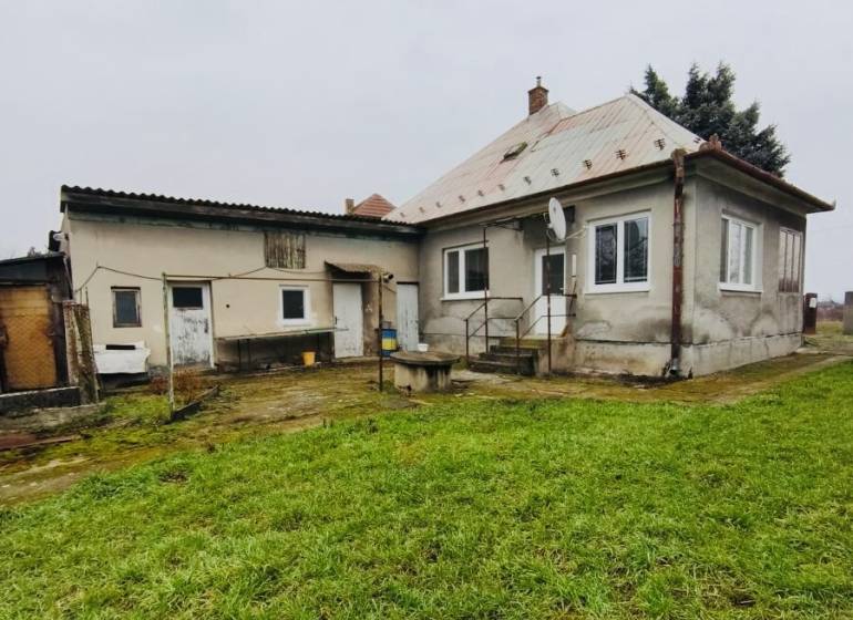 A family house on Seredska Street in Hlohovec with an older roof, garden, and plaster.