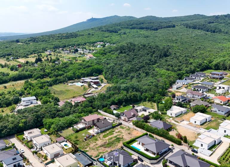 Aerial view of residential plots between streets and greenery in Štitáre on Pod Agátmi.