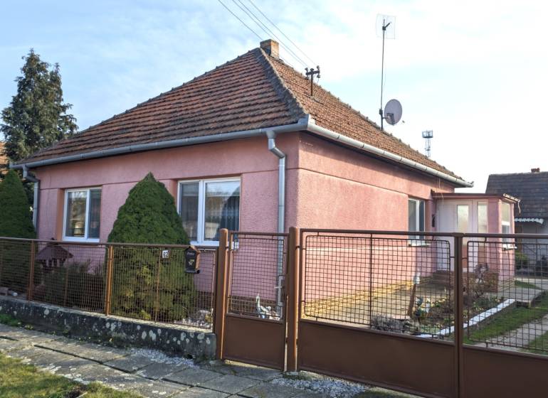 A family house on Martinová Street in Lúčnica nad Žitavou with a landscaped garden and a gate.