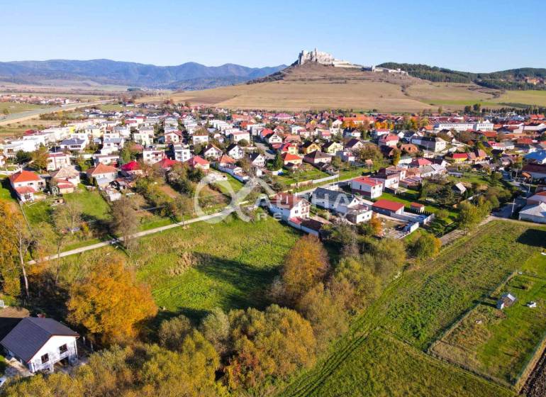 Aerial view of residential plots in Spišské Podhradie with a panorama of the castle.
