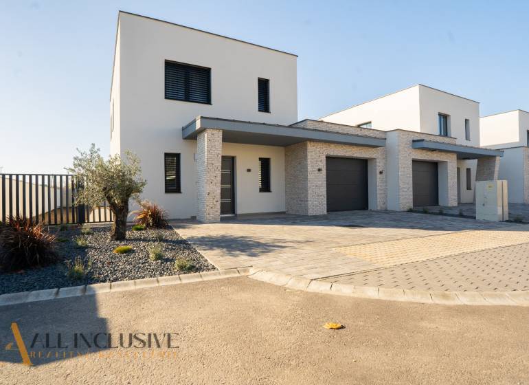 Family house in Gyor-Moson-Sopron, with a garage, minimalist front garden with stones.