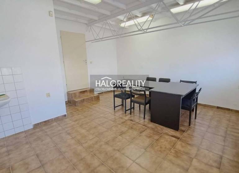 Offices with a dining table and tiles, a sink in the corner of the room.