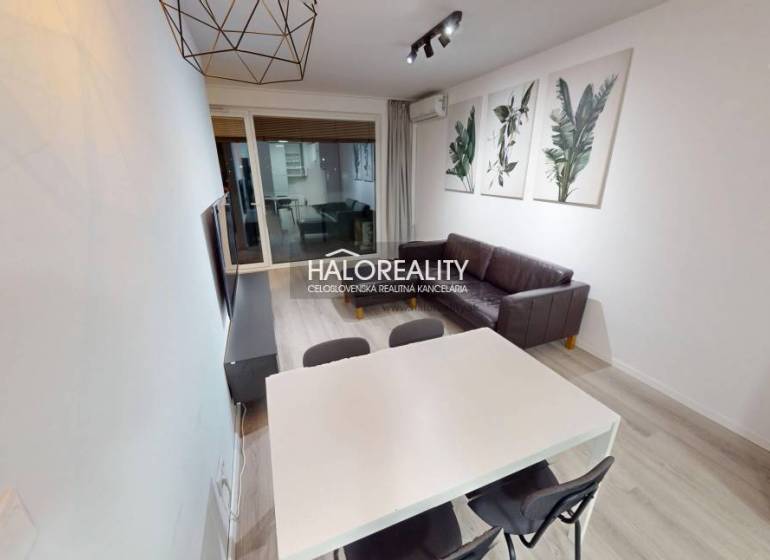 Bathroom with a round mirror and sink in a 2-room apartment.