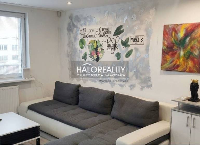 Living room in a 3-room apartment with a comfortable sofa and a decorative wall.