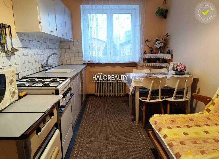 Kitchen in a 2-room apartment with a kitchen table and a gas stove.