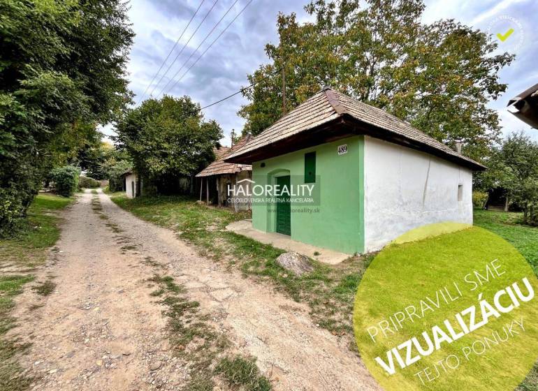 A country house in Záhrady near Mýtne Ludany, surrounded by trees and a gravel road.