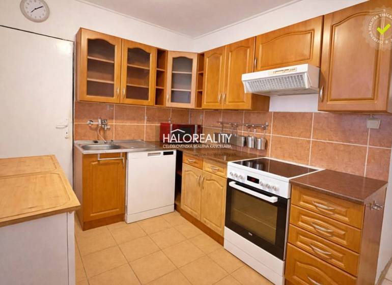 A kitchen in a 4-room apartment with a wooden floor decor and a kitchenette.