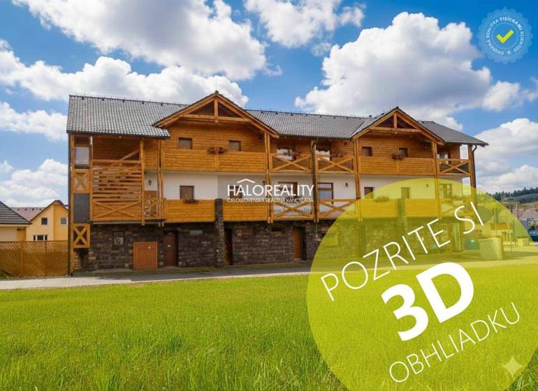A wooden building in Demänovská Dolina with a blue sky and green grass.
