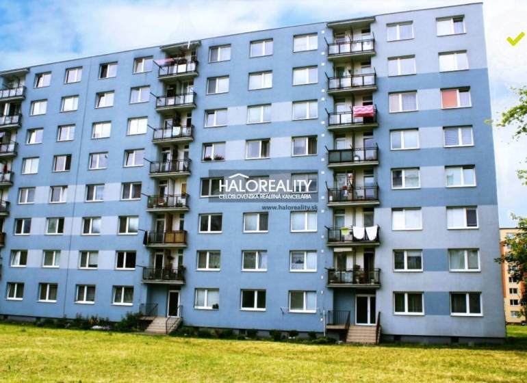Apartment building with balconies and greenery in Liptovský Mikuláš, suitable for a 2-room apartment.