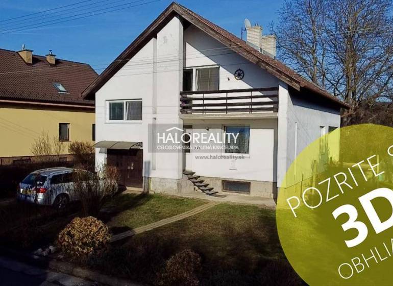 A family house in Čerenčany with a garage, a car in front of the house, and a landscaped garden.