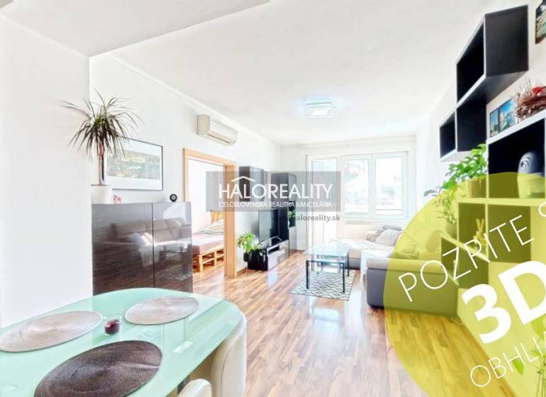 Bright living room in a 3-room apartment with wood-patterned flooring and plants.