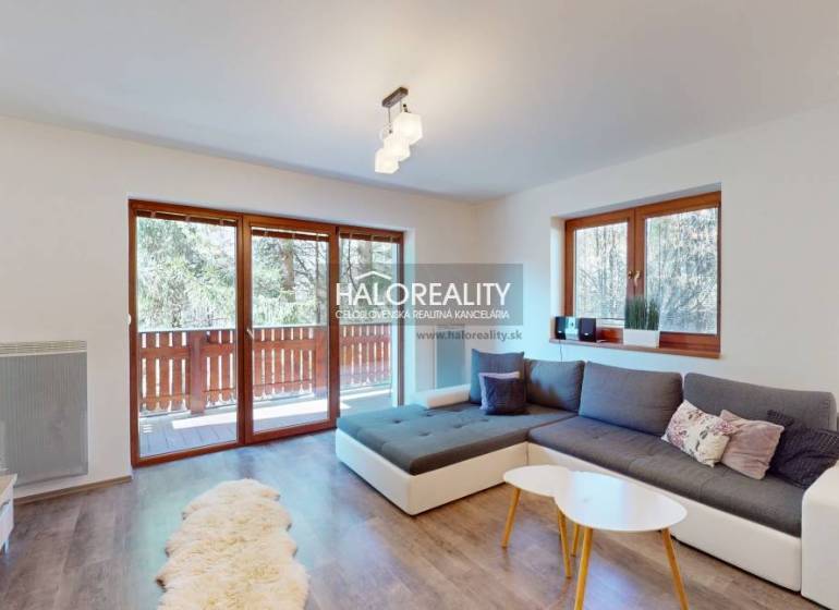 A bright living room with a large window, a sofa set, and wooden flooring in a 3-room apartment.