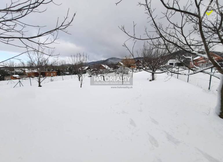 Snow-covered residential plots in Ruská Nová Ves with trees and mountain views.