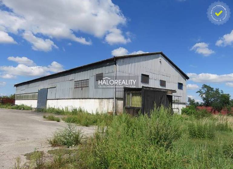 Warehouses and halls in Hurbanova Ves with metal structures and lush vegetation.