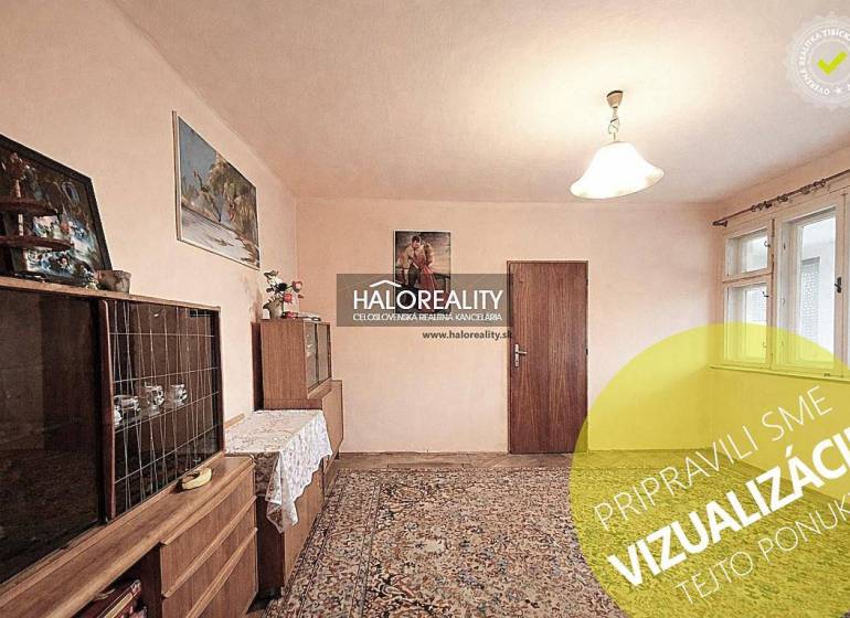 Interior in a family house with furniture, carpet, and paintings on the walls.
