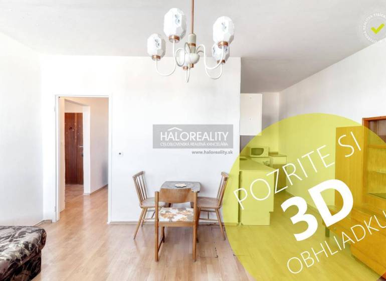 Dining table and chairs in a 2-room apartment with a wooden decor floor.