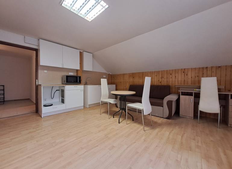 A cozy apartment with a kitchen, wooden decor flooring, and a dining table in a 3-room flat.