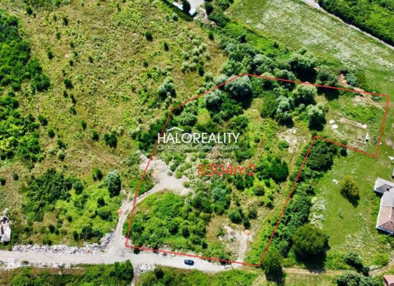 Aerial view of extensive residential land in Tornaľa, surrounded by greenery.