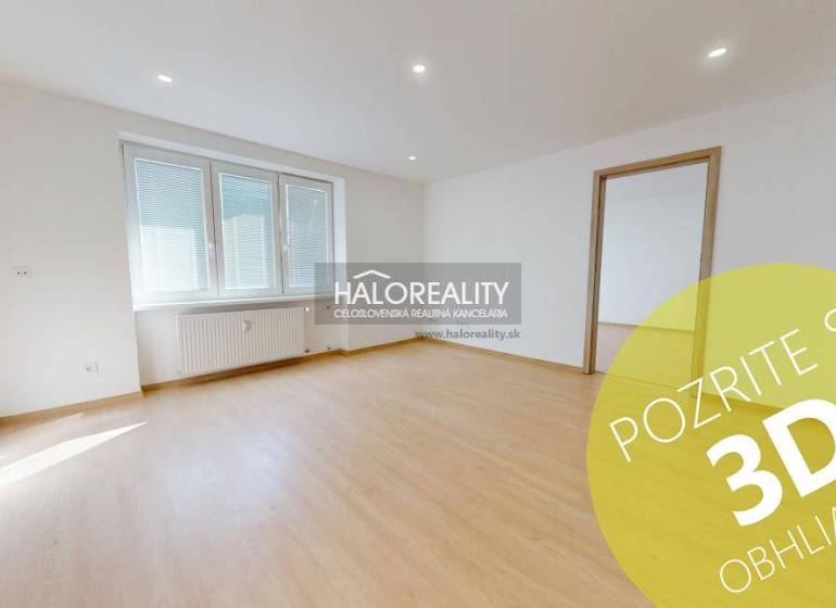 Bright living room in a two-room apartment with wood-patterned flooring.