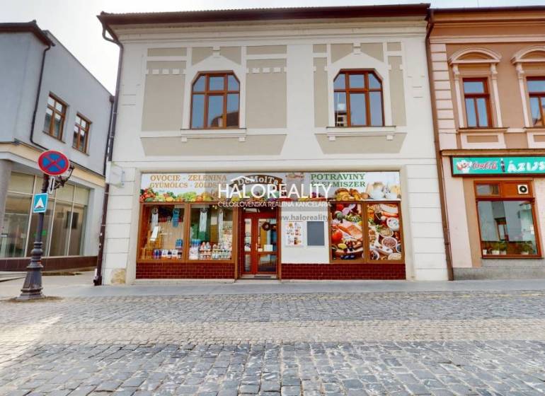 Commercial premises in Rimavská Sobota, facade with signs and pedestrian zone.