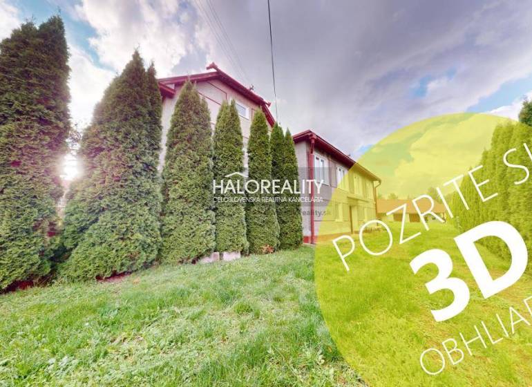 A family house in Hrachovo surrounded by conifers and lawn, sunny weather.