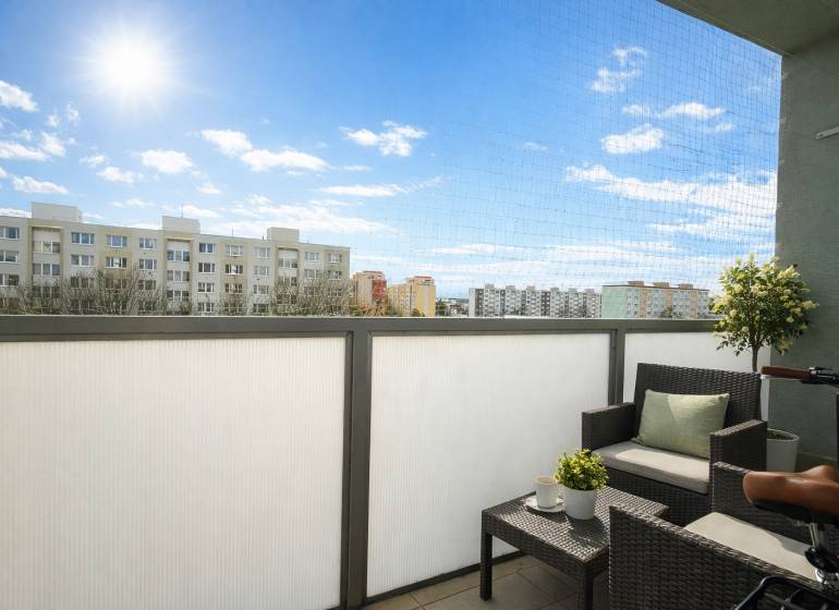The balcony of a one-room apartment on Golianova Street in Trnava with comfortable seating and a view.