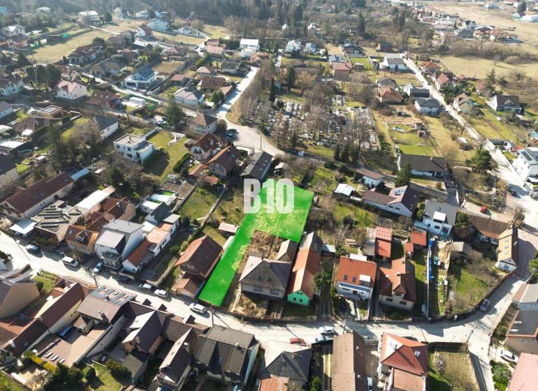 Aerial view of residential plots in Marianka, surrounded by houses and greenery.