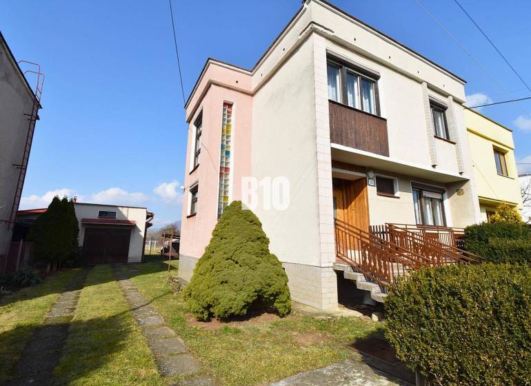 A family house in Žilina with a garage, garden, and driveway in a quiet neighborhood.