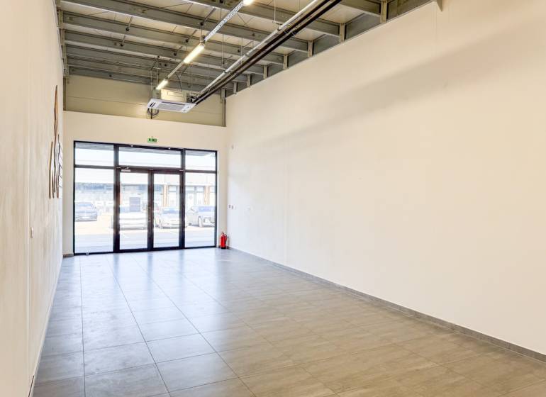 Spacious commercial premises with tiles and large doors.