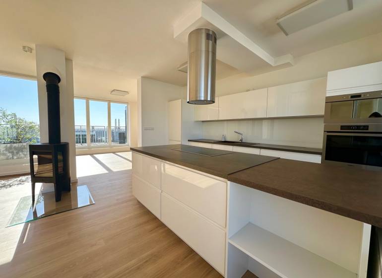 A kitchen in a 4-room apartment with a fireplace and a floor with a wooden decor.