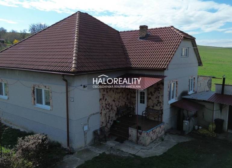 A family house in Rimavské Janovce with a red roof and a rural surrounding environment.