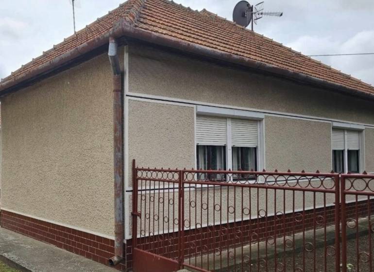 A family house in Radava on Hlavná Street with a red roof and white shutters.