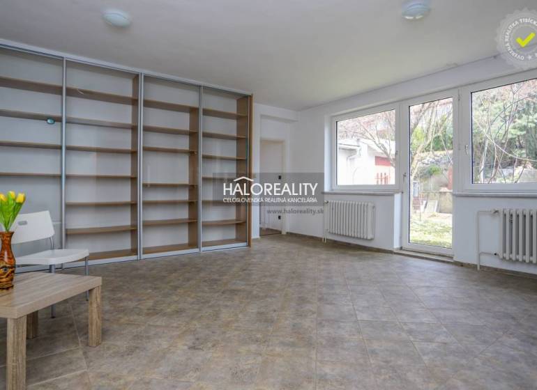 A spacious room in a family house with large windows and a built-in wardrobe.