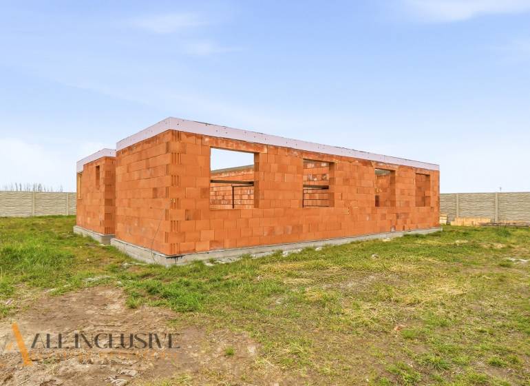 A family house under construction made of bricks with a plot in Veľké Dvorníky.