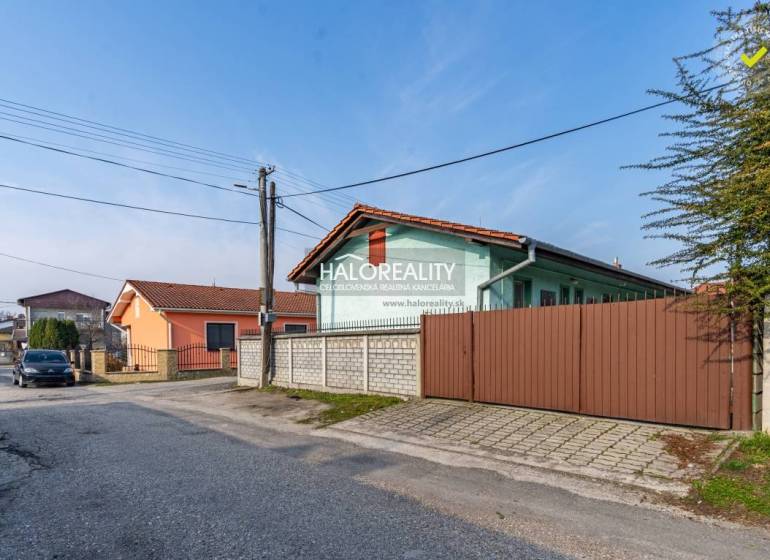 Street with family houses and a car in Veľký Meder, Hotels and guesthouses in the vicinity.