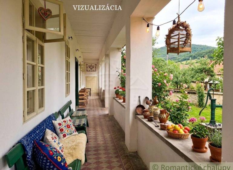 The veranda of a family house in Dobroč with decorations, cushions, and a view of the garden.