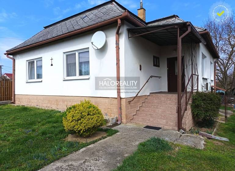 A family house in Hráň with a white facade, staircase, and garden.