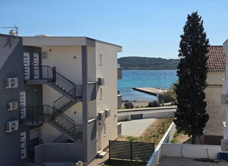 A view of the surroundings in Srima with a view of the sea and an apartment building.
