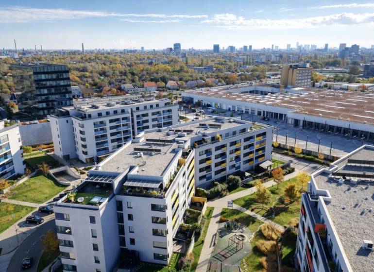 Aerial view of residential buildings with a playground on Malokrasňanská Street in Bratislava-Rača.