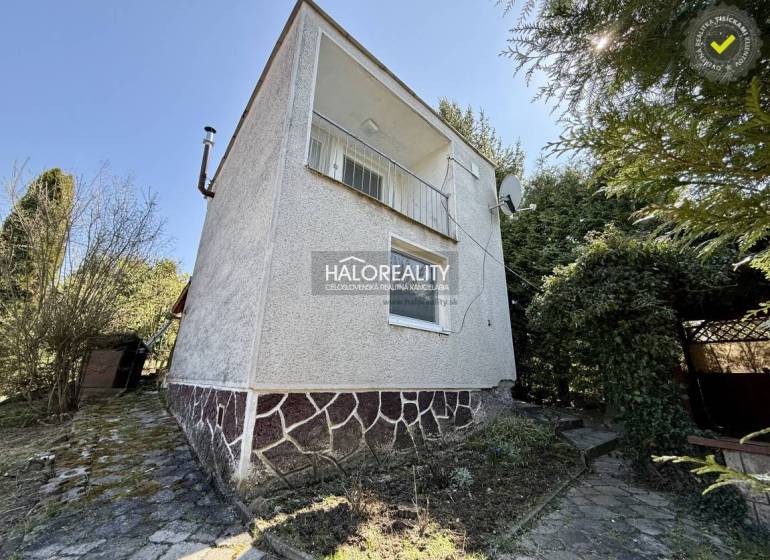 A family house surrounded by trees and shrubs in the gardens of the city of Rimavská Sobota.