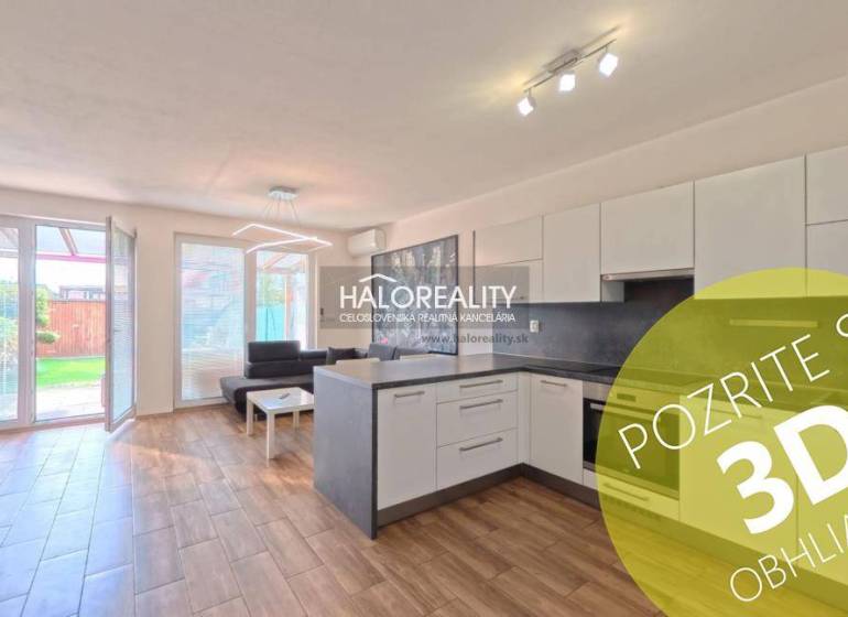 Kitchen and living room in a 2-room apartment with a wooden decor floor, access to the terrace.