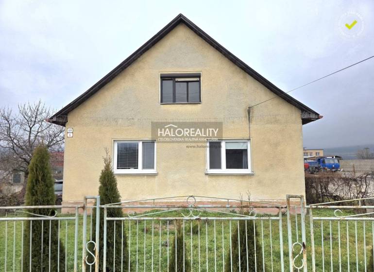 A family house in Čereňany with a simple facade and a front garden behind a fence.