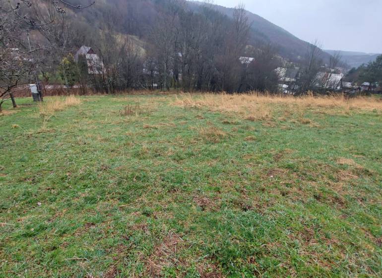 Grassy recreational plots in Púchov with views of the surrounding nature and village houses.