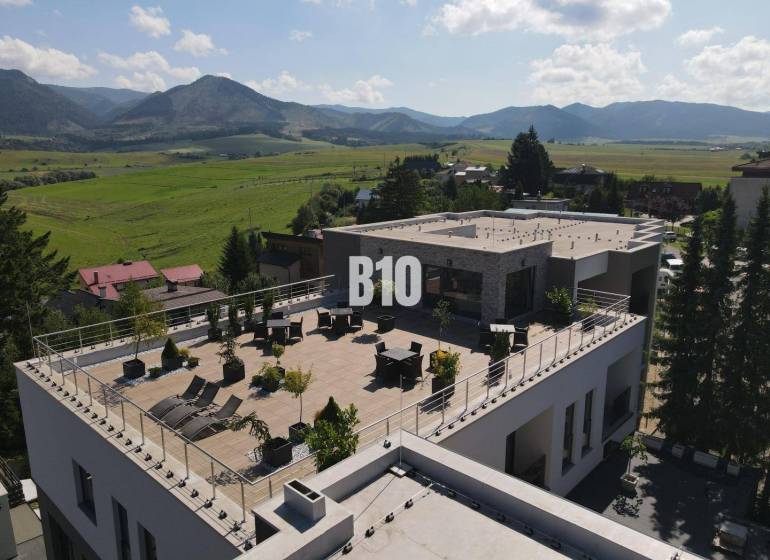 Rajecké Teplice, M. R. Štefánika: A building with a spacious terrace and a view of the mountains.