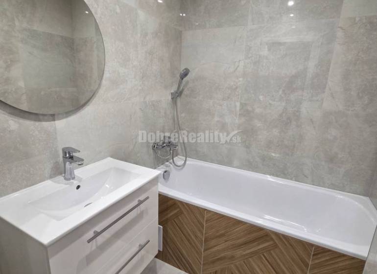 Bathroom with a bathtub and a white cabinet in a 3-room apartment.