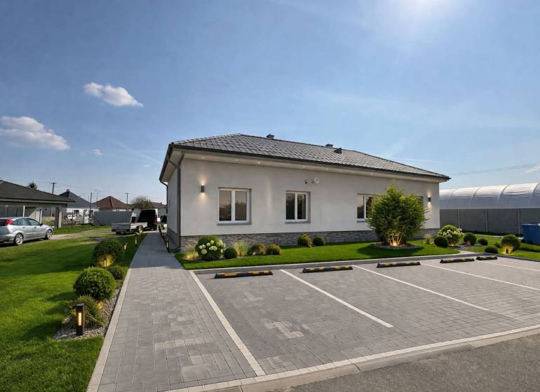 A family house in Zemianska Olča with a garden, parking, and a paved walkway.