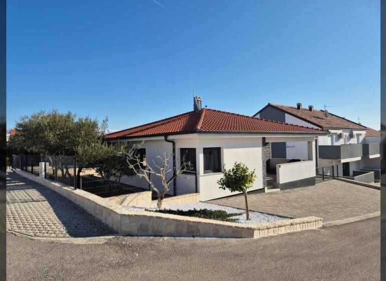 A family house in the town of Vrsi on Mulo Street has a red roof and stone walls.