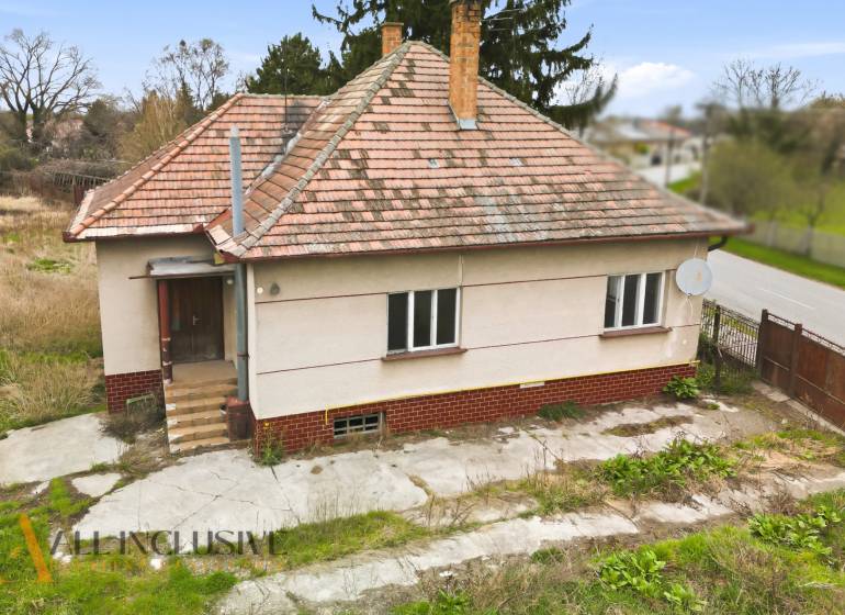 A family house in Michal na Ostrove with a sloped roof and a satellite dish.