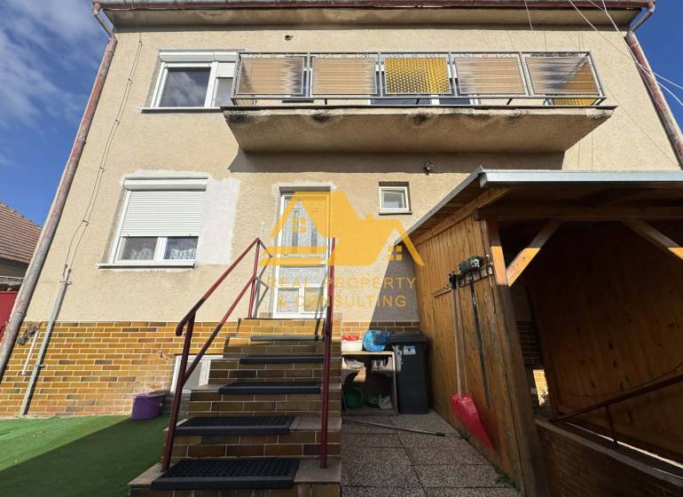 Family house in Tvrdošovce on Tvrdošovce street with an outdoor staircase and a balcony.