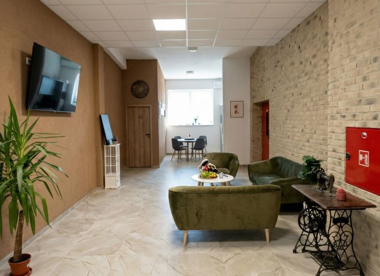 Offices with comfortable seating, a plant, and a television, floor with wood decor.